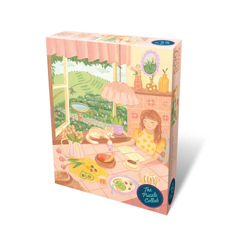Puzzle box with a colorful illustration of a woman at a table with a garden view.